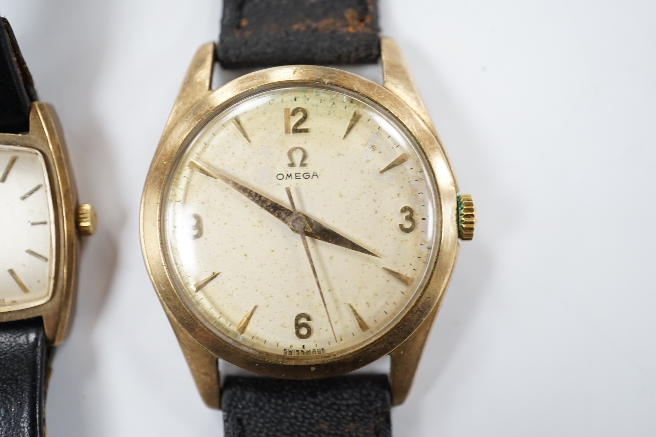 A gentleman's 9ct gold Omega manual wind wrist watch, on associated strap and a lady's 9ct gold Omega manual wind wrist watch.